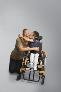 Lori hugging her son Julian who is in a wheelchair